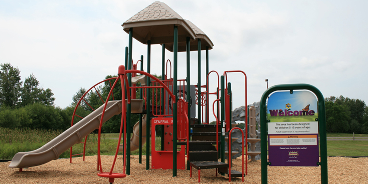 Park Playground With Slides and Swings