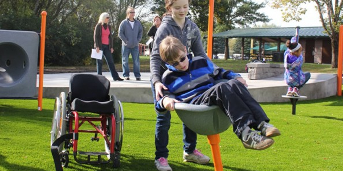 Physically Disabled Child on Specialized Playground Equipment