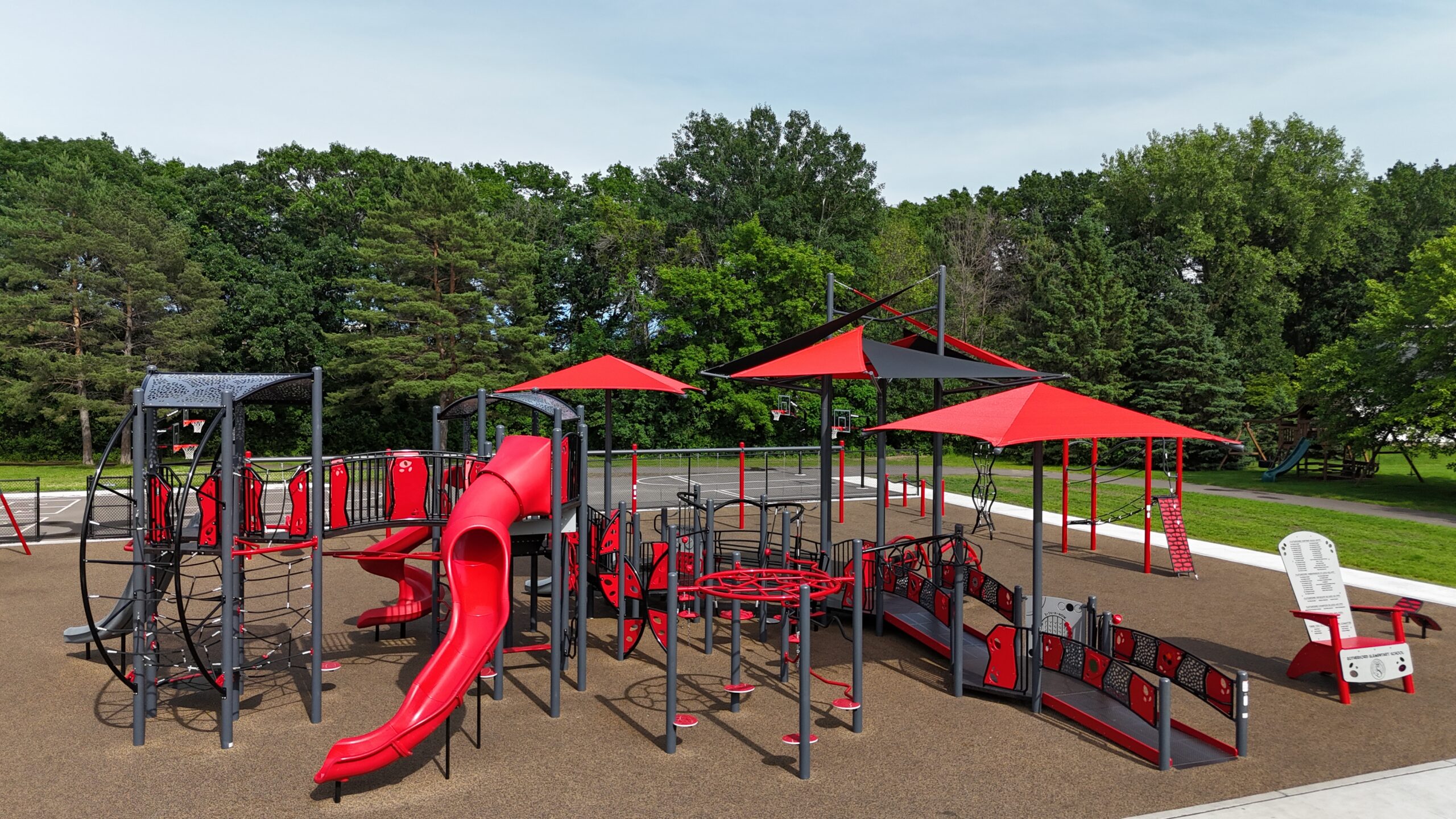 Inclusive playground at Rutherford Elementary School in Stillwater, Minnesota featuring shade structures and play systems